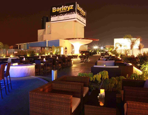 Hospitality project — rooftop fine-dining restaurant with open kitchen and warm ambient lighting